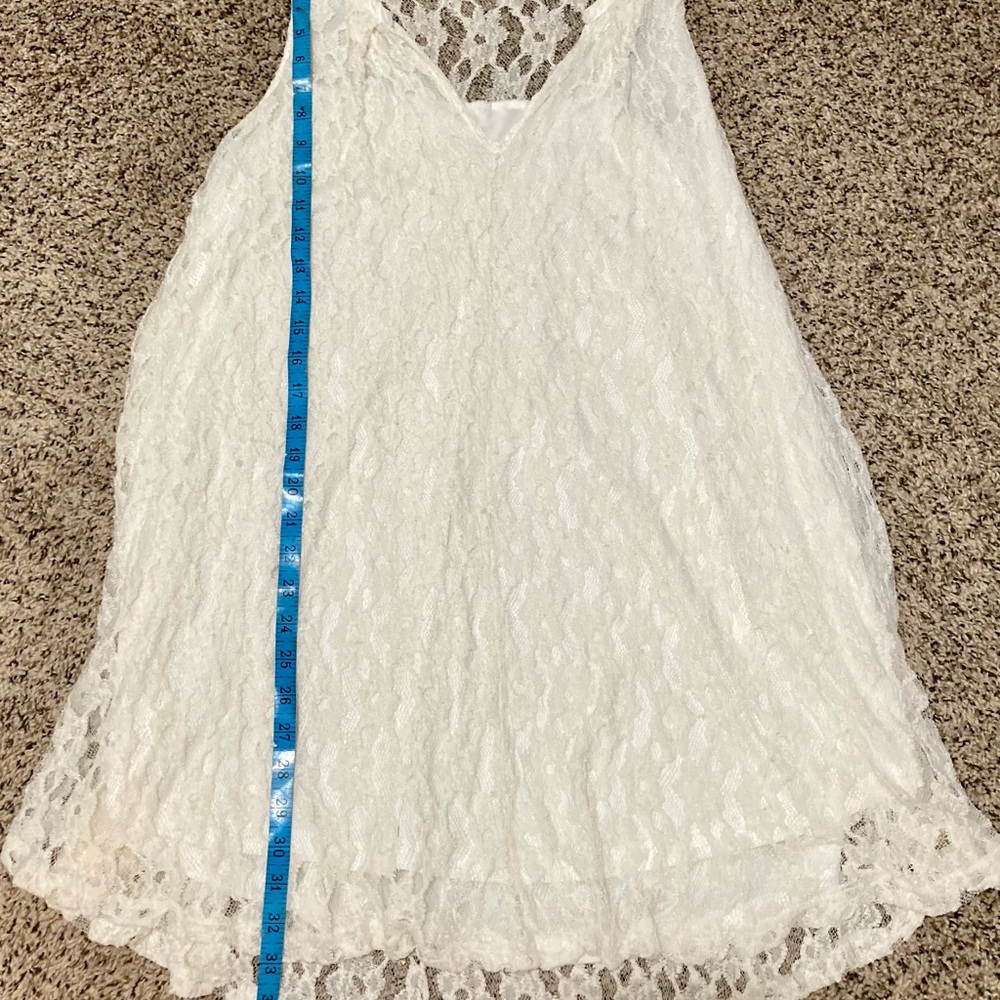 Cream colored sleeveless stretch, lace flowy dress with built-in slip lining